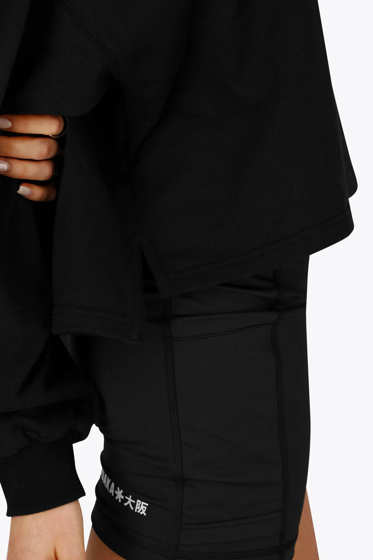 Osaka women cropped hoodie in black with college logo in white. Side view