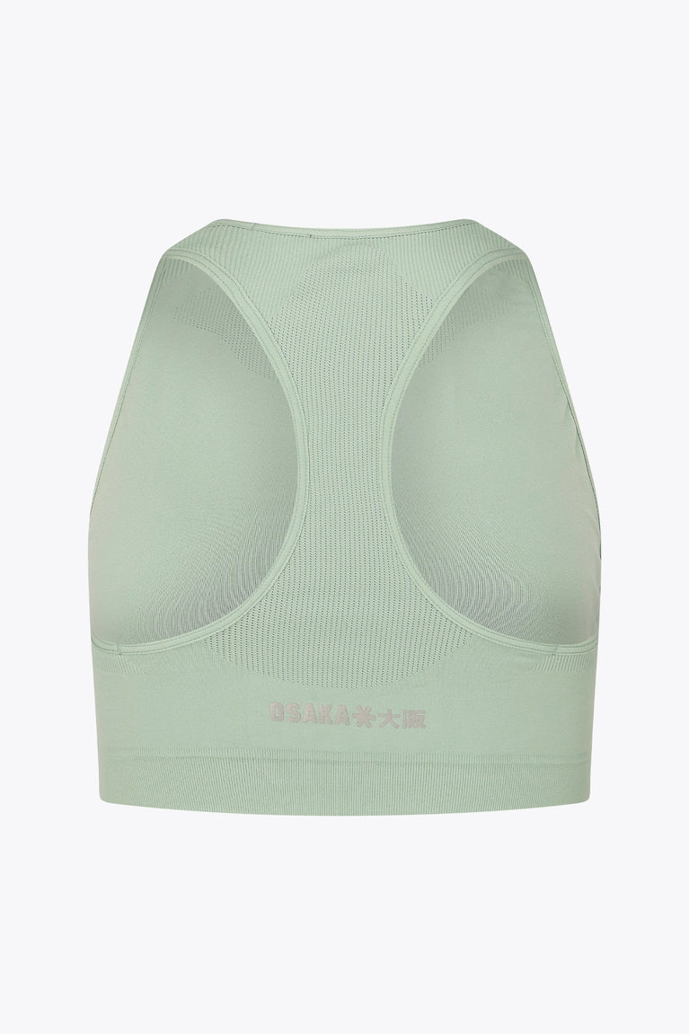 Osaka women tech sports bra in jadeite with logo in grey. Back flatlay view