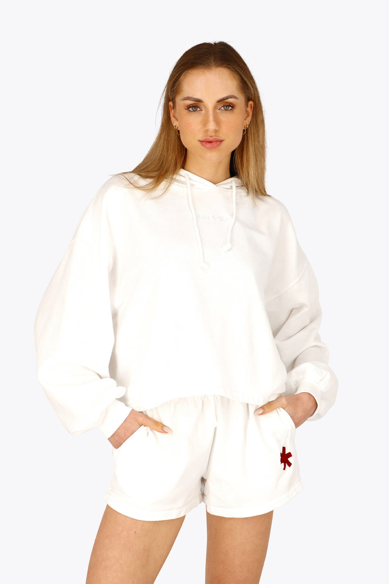 Woman wearing the Osaka women cropped hoodie in white with logo in white. Front view
