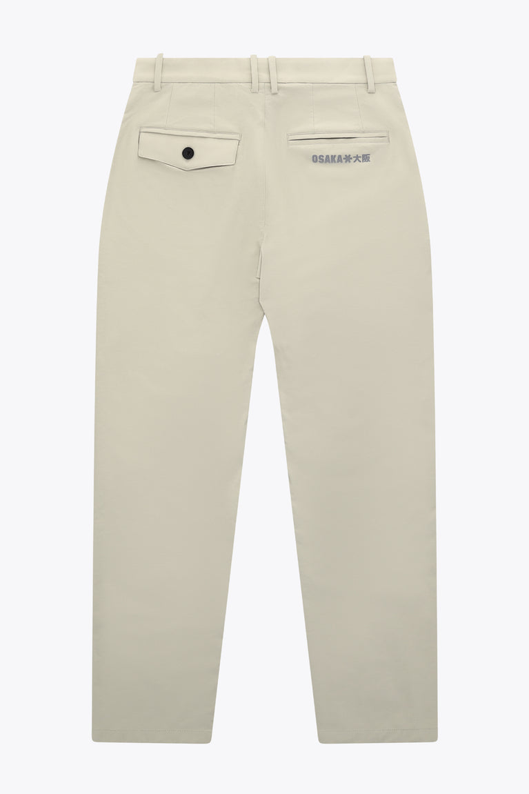 Beige men’s technical golf pants with back button pocket detail and logo patch