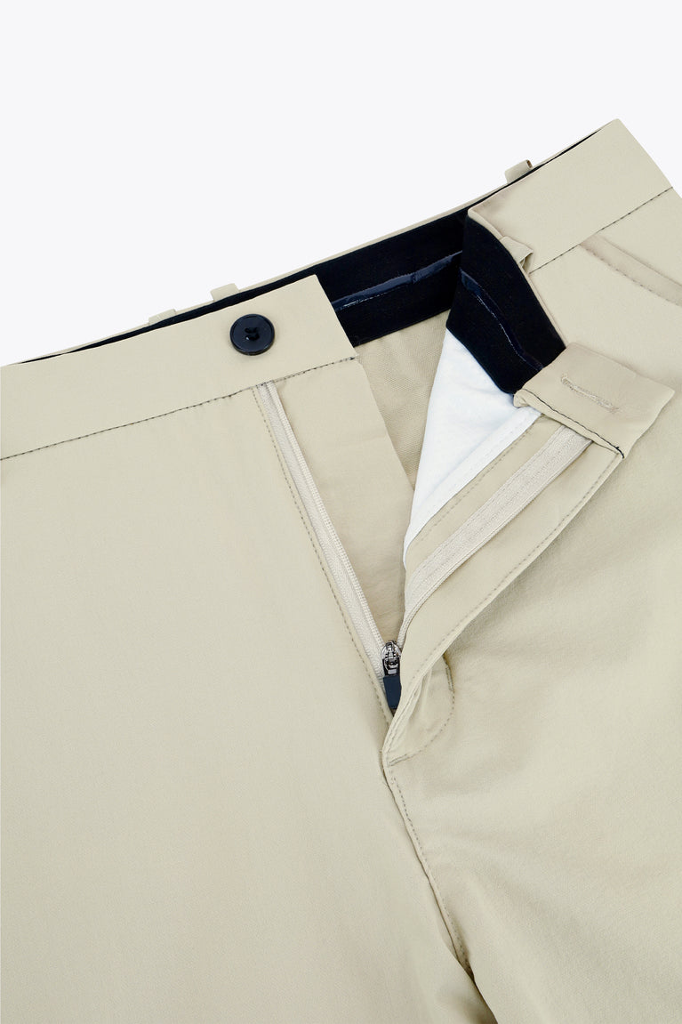 Beige golf pants with inner waistband lining and zip-fly opening detail