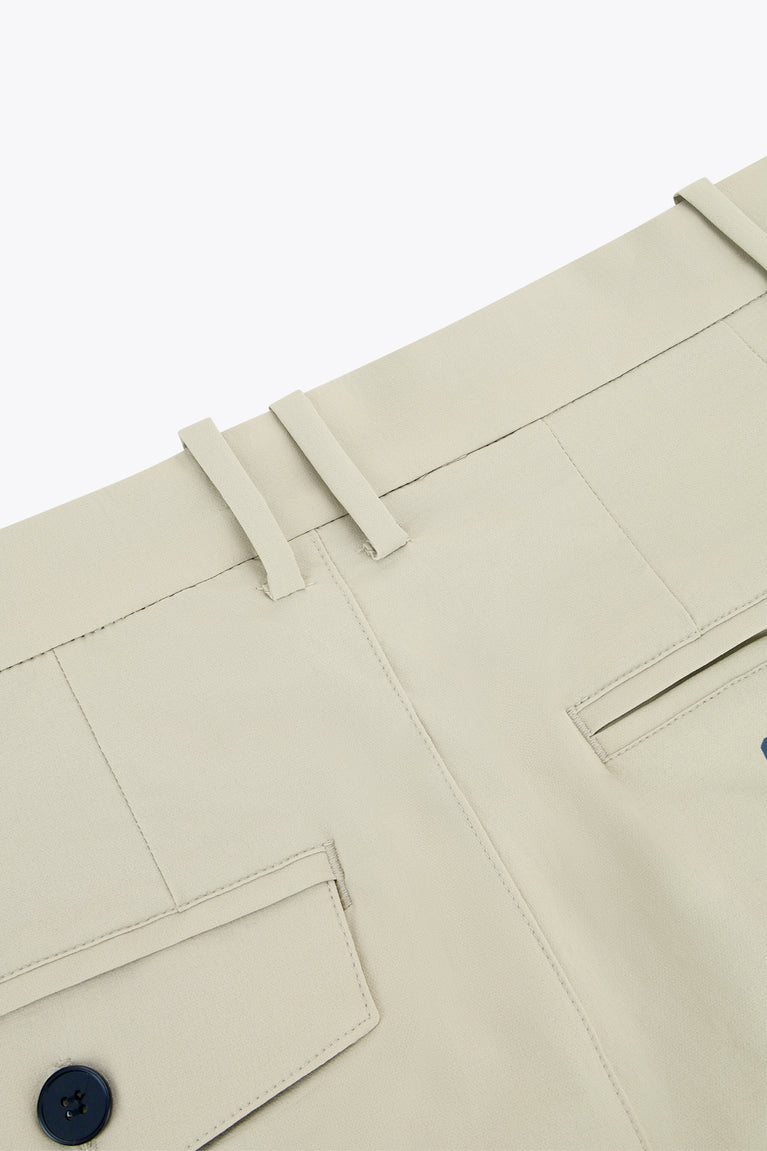 Beige technical golf pants close-up of belt loops and stitched front pocket
