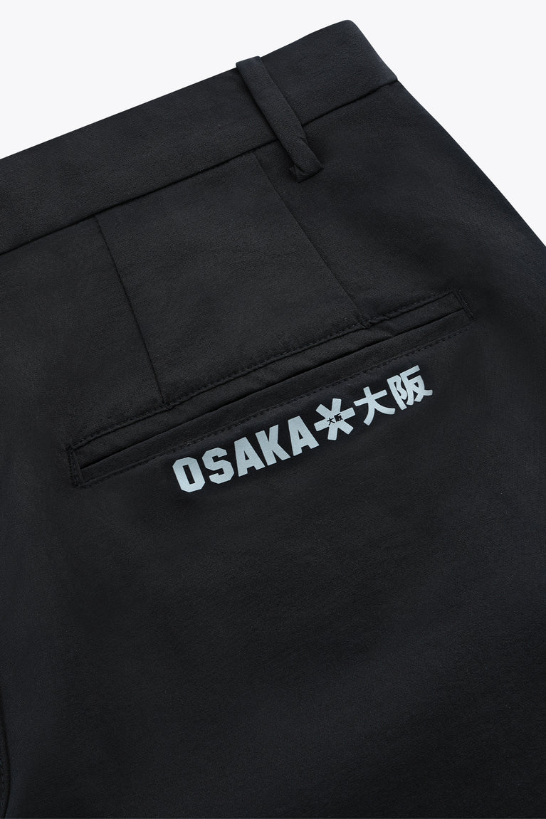 Black men’s technical golf pants with embroidered “OSAKA” logo on thigh