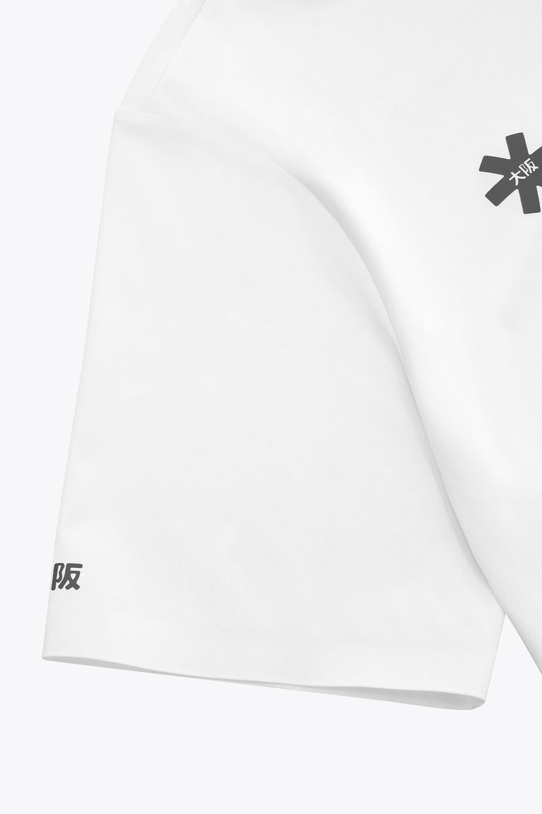 White polo shirt sleeve and curved side hem with small printed mark