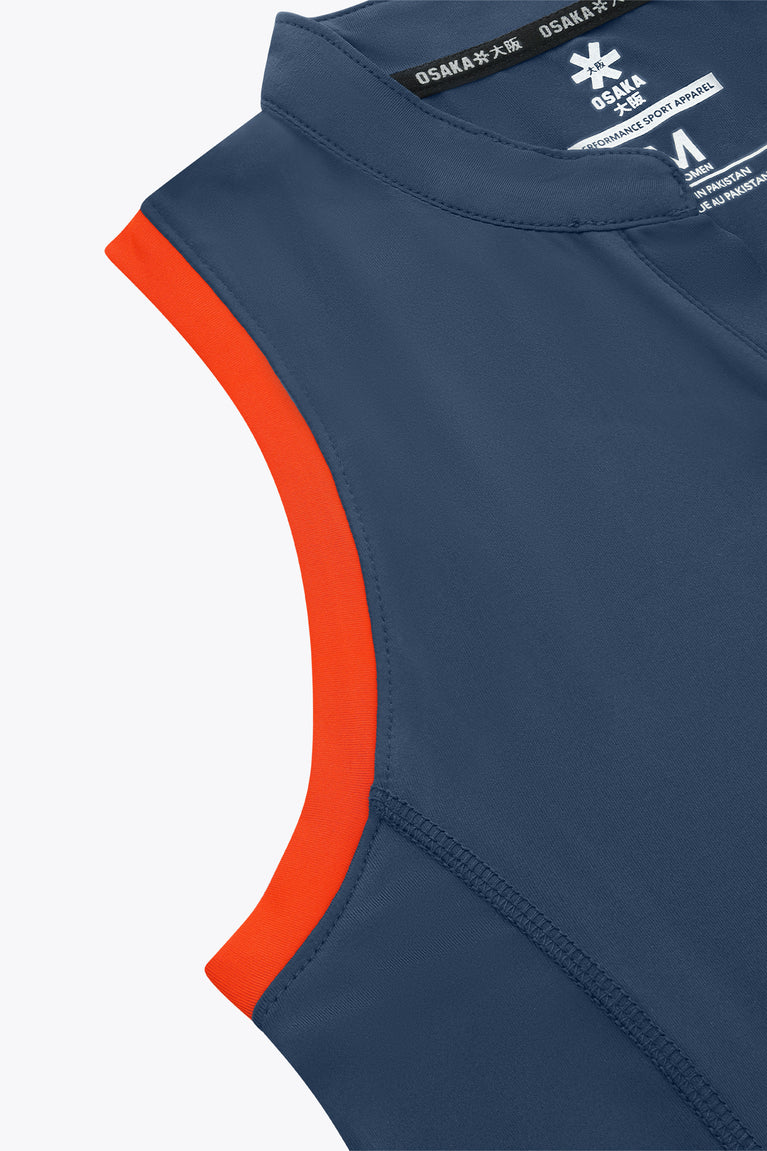 Women’s court tank top close-up, navy-blue with orange side panel and stitching