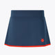 Women’s floucy skort by Olympian in dark navy with red hem trim and logo.