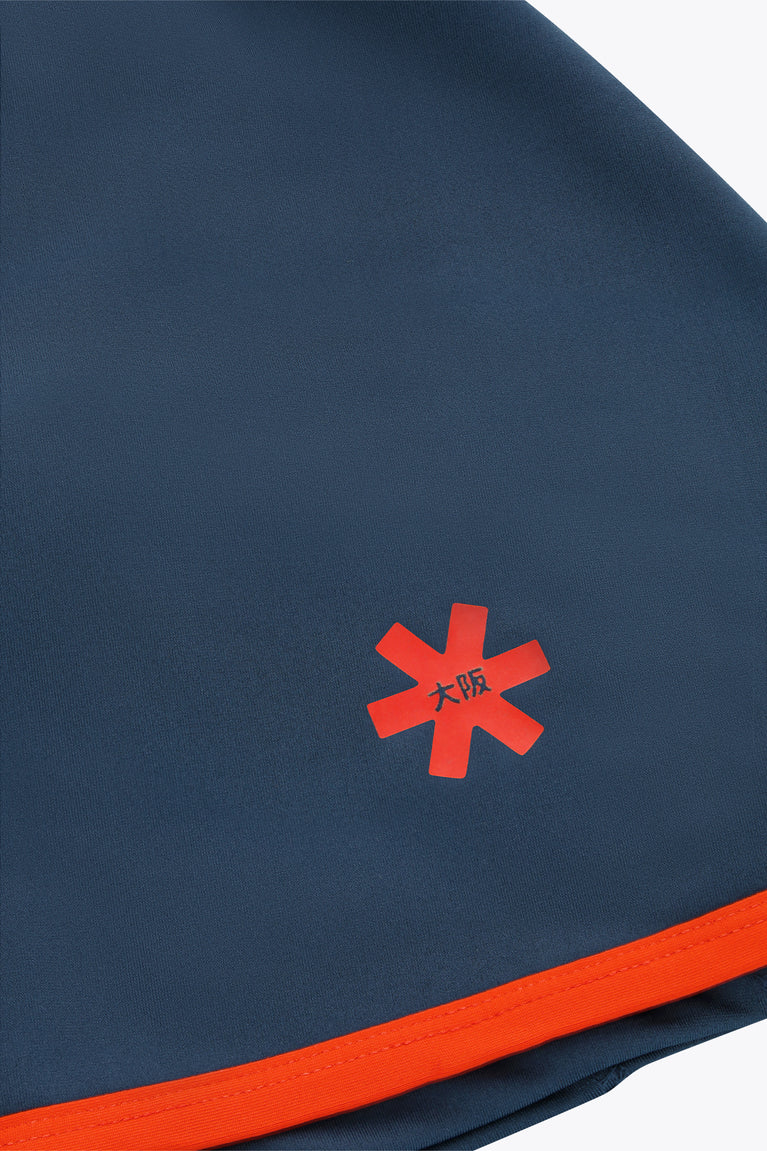Dark navy skort with red starburst logo and red contrast hem.