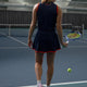 Women’s floucy skort by Olympian, dark navy with red trim and rear logo.