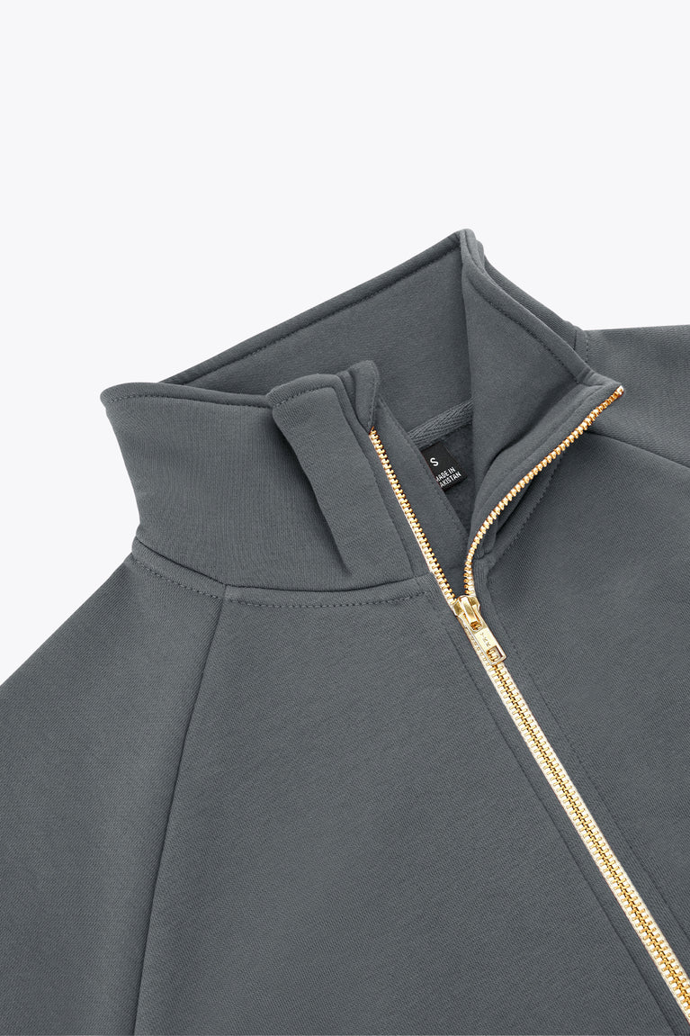 Women’s full-zip sweater collar detail with gold-and-orange zipper