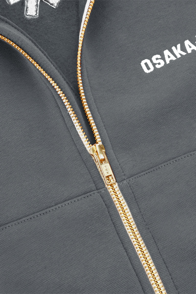 Women’s full-zip sweater with gold zipper and OSAKA logo on chest