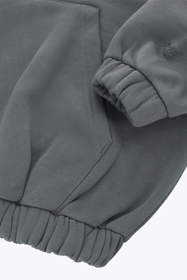 Women’s full-zip sweater sleeve cuff and pocket detail with ribbed hem