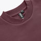 Close-up of men's pullover sweater collar in dark maroon with ribbed crew neckline