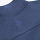 Men's navy half-zip sweater with embroidered logo at the stand collar.