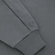 Dark grey half-zip sweater sleeve cuff with small logo stitch and ribbed trim