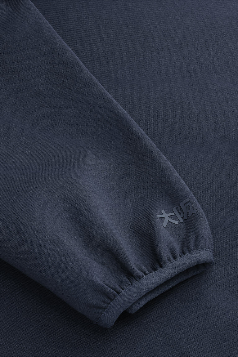 Navy knit sweater sleeve cuff with ribbed hem and seam detail