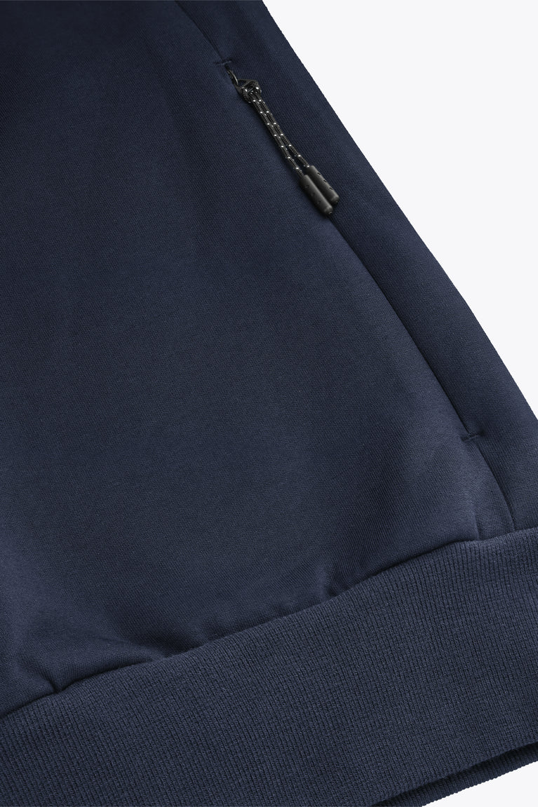 Navy knit sweater sleeve with small metal zipper accent and ribbed cuff