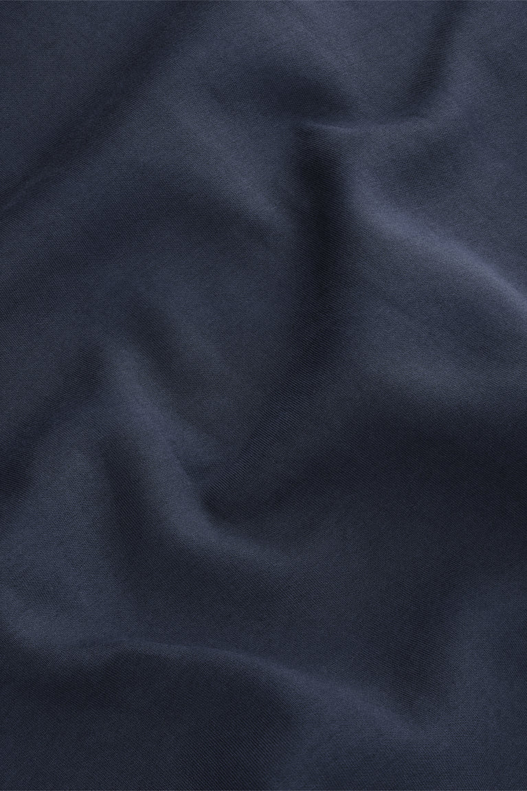 Navy knit sweater fabric close-up with smooth, dense texture