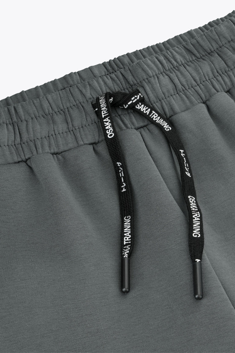 Dark grey sweatpants waistband with elastic casing and black drawstring