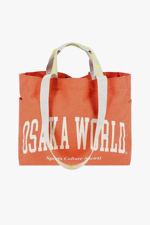 Osaka cotton tote bag in peach with logo in white. Front view