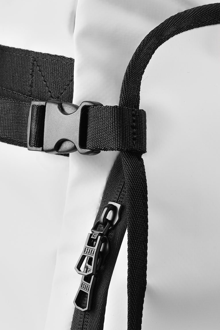 Stickbag close-up of straps and metal buckle hardware on black webbing.