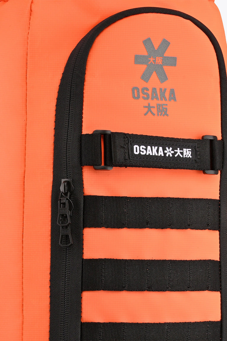 Close-up of inner pocket on orange stickbag with black webbing and Osaka label.