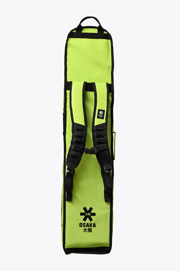 Lime green stickbag with black straps and side carry handles, back view