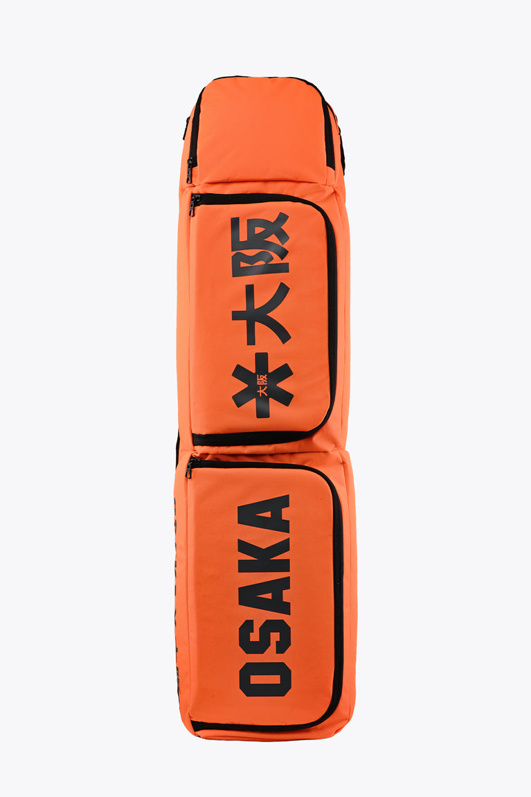 Orange stick sports stickbag with black trim and two front padded compartments