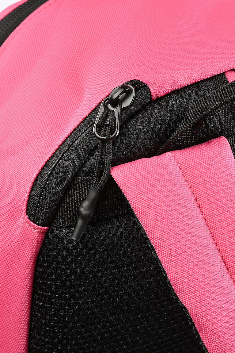 Hot pink backpack zipper and black mesh strap close-up