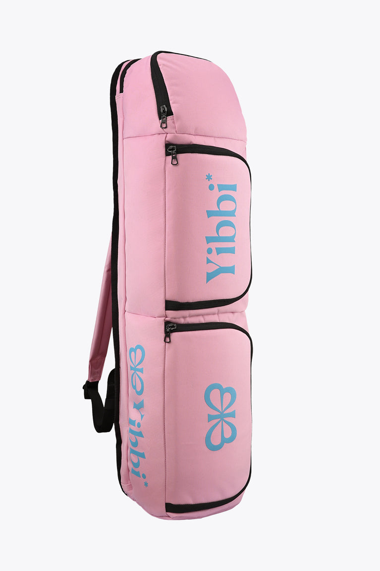 Pastel pink sports stickbag with two stacked zip compartments and blue logo patch