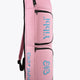 Pastel pink sports stickbag with two stacked zip compartments and blue logo patch