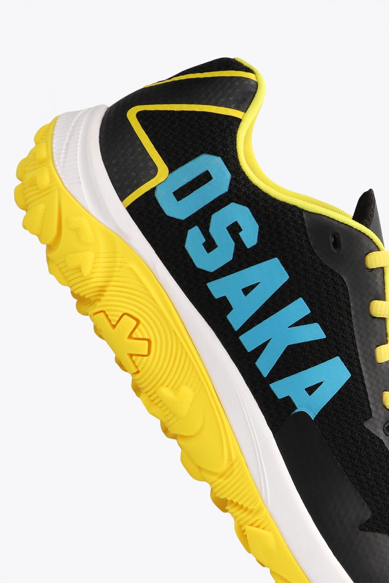 Osaka footwear Kai Mk1 in black and yellow with logo in blue. Detail logo view