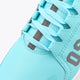 Kids light-blue sneaker upper close-up with lace-up, gray strap accents