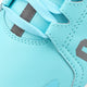 Kids light-blue sneaker side close-up with textured stitching, lace loops, logo patch