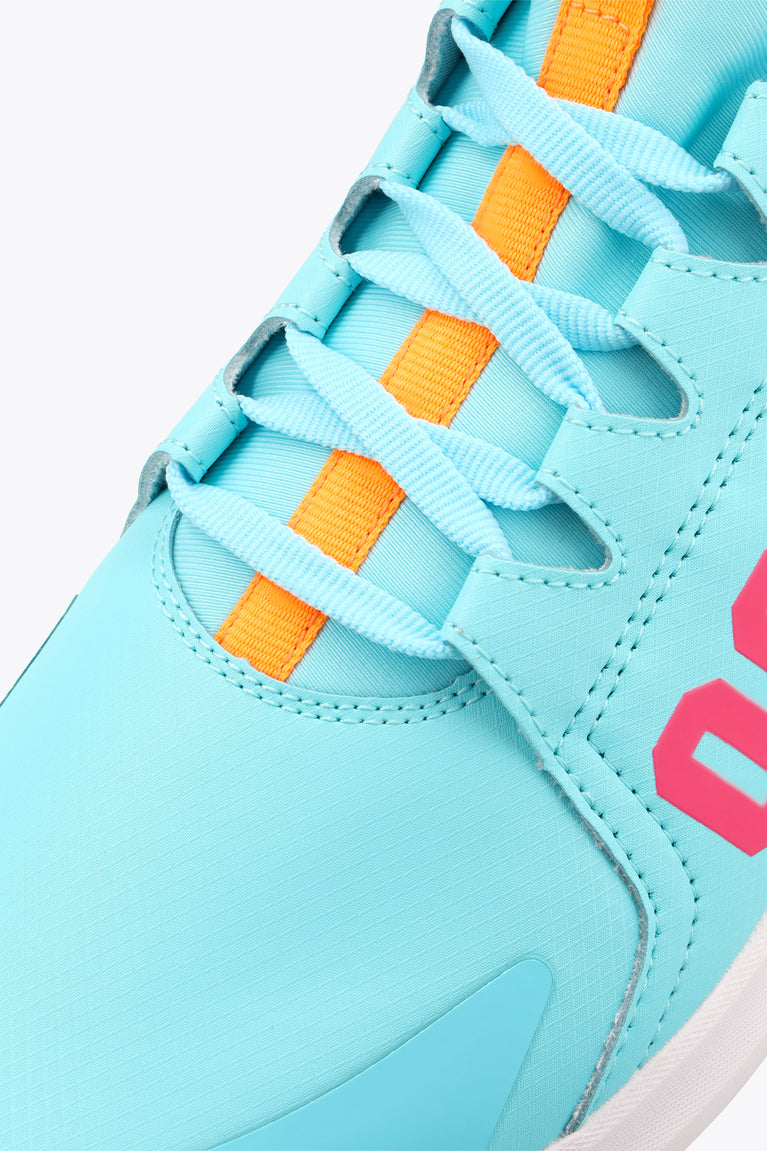 Light blue sneaker upper with orange lace-strap details and stitched overlays