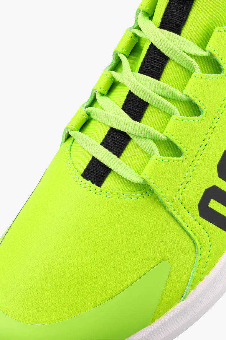 Lime green lace-up sneaker upper with black strap accents and stitched toe