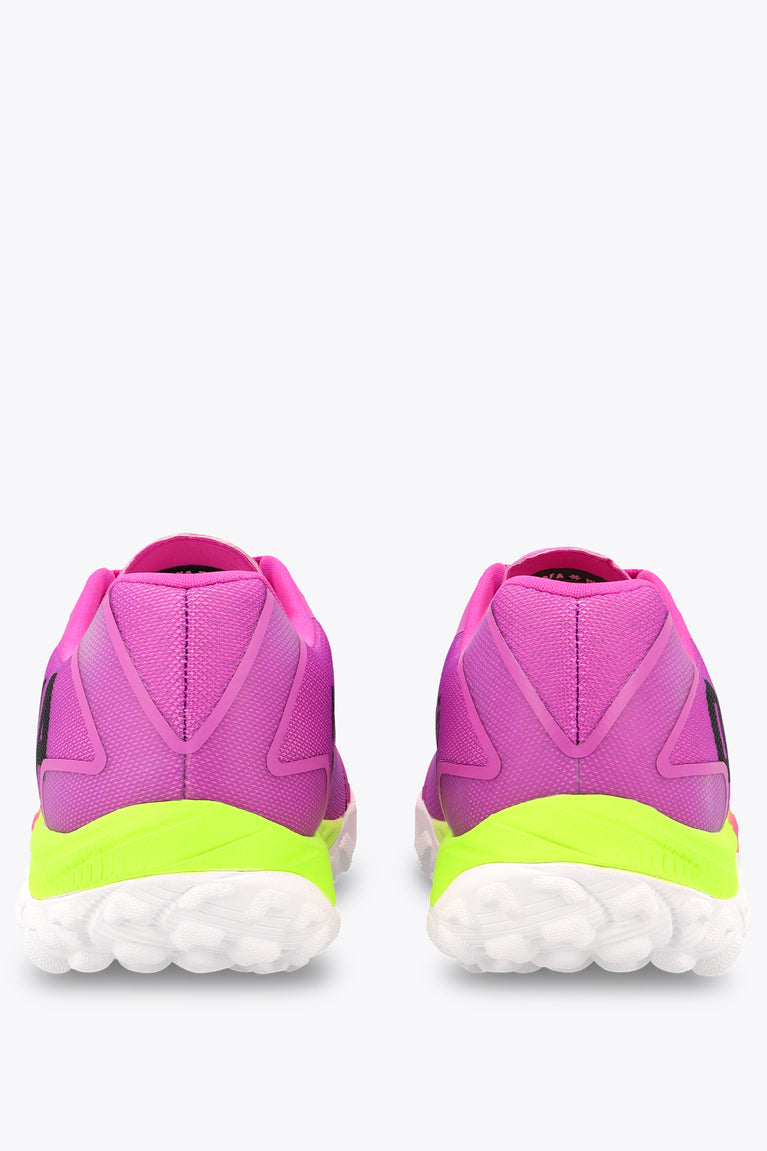 Rose bud pink sneakers showing heels, neon green midsole, and white tread outsole