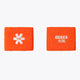 Orange terry sweatband wrist pads with Osaka logo and Japanese text