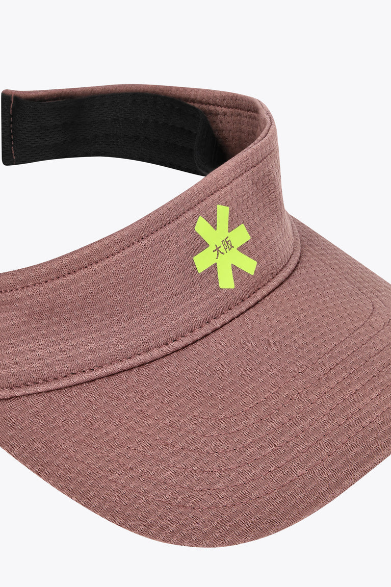 Peppercorn visor close-up with stitched texture and green emblem on front