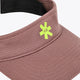 Peppercorn visor close-up with stitched texture and green emblem on front