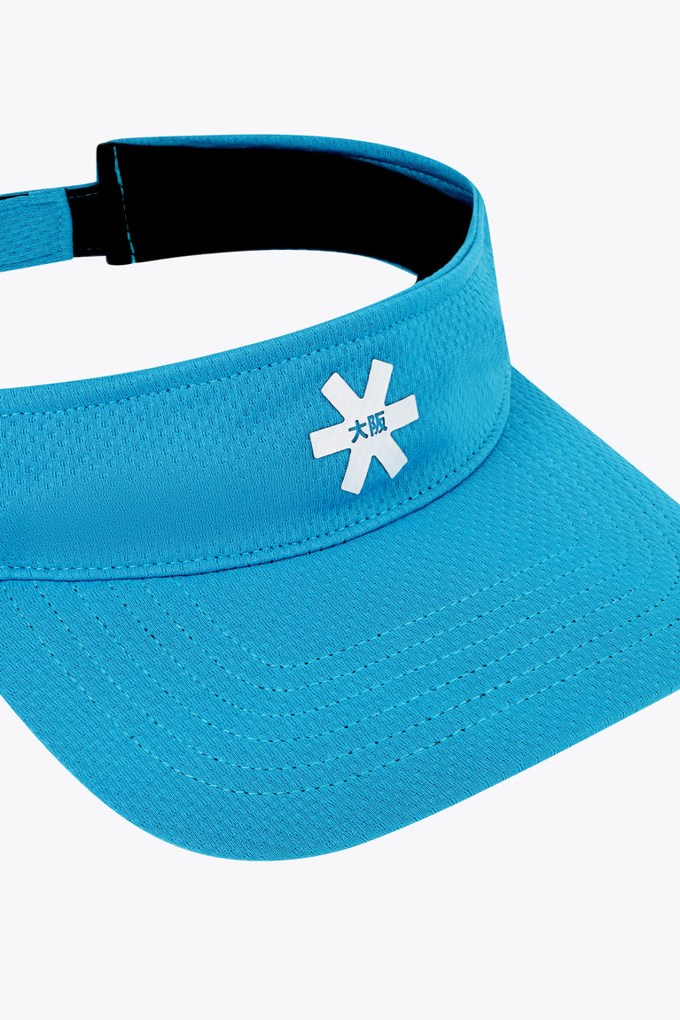 Osaka visor close-up in blue topaz with front logo and black backing strap