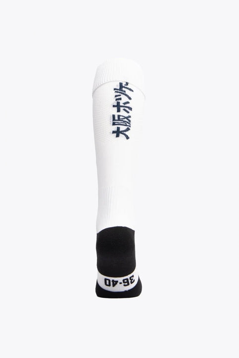 Egara Field Hockey Socks | White Egara Socks in white with Osaka logo in green. Front view
