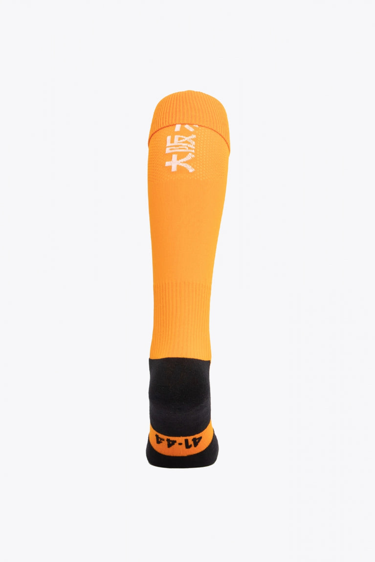 NHM Field Hockey Socks in orange with Osaka logo in green. Back view