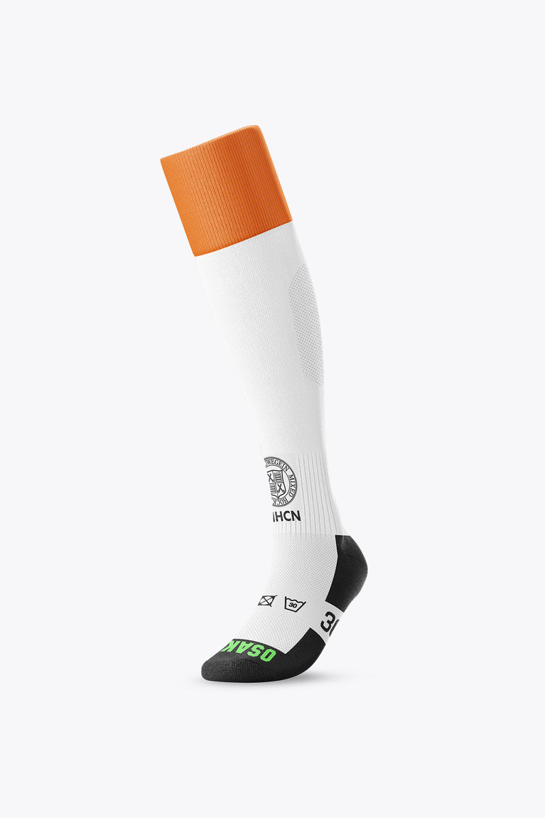White field hockey socks with orange cuff and black heel and toe