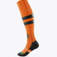 Orange field hockey socks with black mid-calf band, black toe/heel, vertical logo and crest