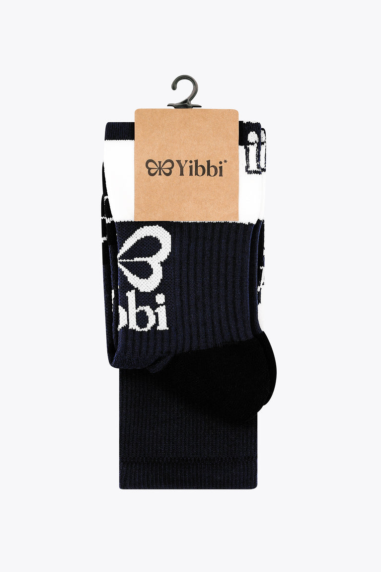 Yibbi field hockey socks on a packaging card; navy crew with white stripe band