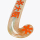 Indoor hockey stick blade end in wood tone with orange star pattern accents