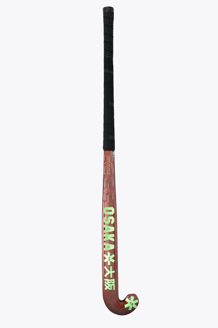 Brown field hockey stick with black butt cap, 'OSAKA' text, and green star decal.