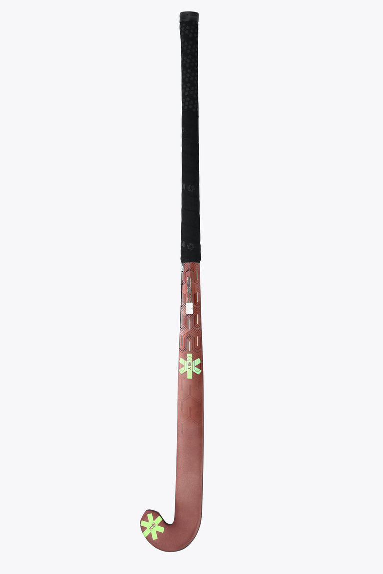 Brown field hockey stick with black grip tape and green star decal at the rounded head.