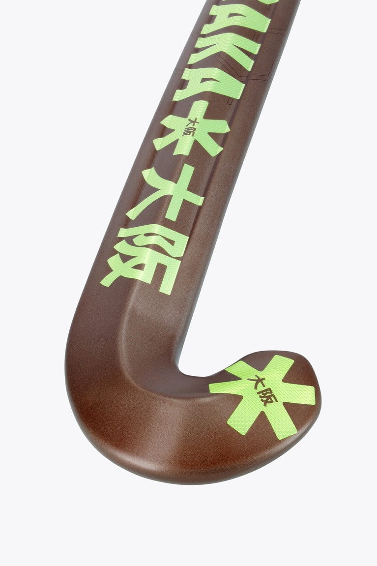 Field hockey stick curved blade end in dark brown with large lime emblem and logo.