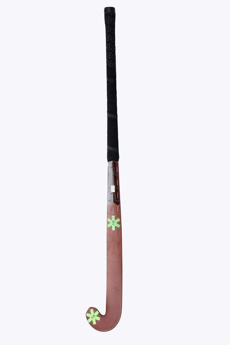 Field hockey stick top-to-blade view showing dark brown head and lime star decals.